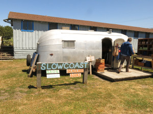 Wallace outside his trailer where he sells 'Slow Coast' merchandise. Photo: Will Fraker. 