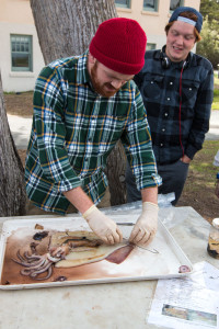Patrick Daniel, a technician in Gilly's lab, dissects a squid at a demonstration outside Hopkins Marine Station. (Photo by Sean Greene)