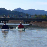 Two kayakers paddle Las Gallinas Creek with Mount Tamalpais in the background