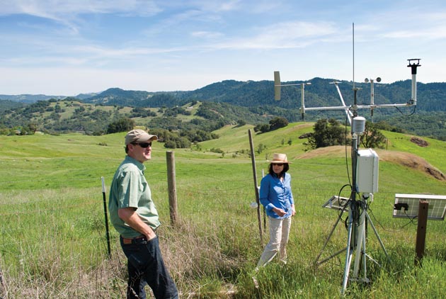 TBC3 co-leaders David Ackerly and Lisa Micheli inspect the project's master fog and weather monitoring station in the grasslands of Pepperwood Preserve. (Photo by Tom Greco, Pepperwood Preserve)