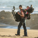 Wildlife photographer Daniel Dietrich and child in carrier at Point Reyes' Kehoe Beach.