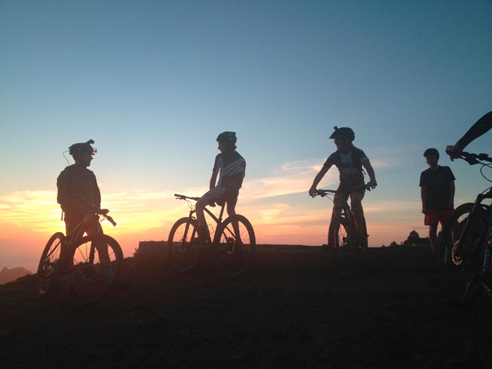 Members of the Berkeley High mountain bike team stop briefly to watch the sunset from the top of Sea View Trail in Tilden Park. (Photo by Karl Nielsen)