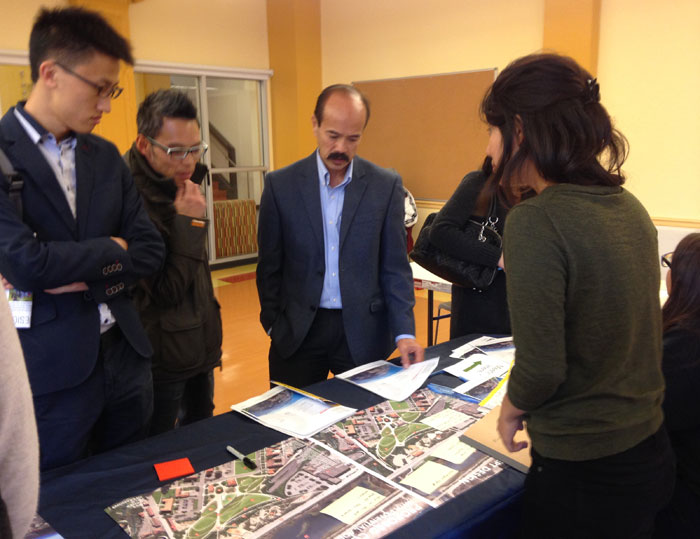 University of Pennsylvania Master of Landscape Architecture graduate student Boqian Xu (left), Tan Chow of the Chinatown Community Development Center (middle), and Amor Santiago of APA Family Support Services (right) look at proposed designs for the Presidio Parklands with Ariel Wang of the Presidio Trust, as part of a community outreach meeting at the Chinatown YMCA.  (Photo by Stella Zouridakis, courtesy Presidio Trust)