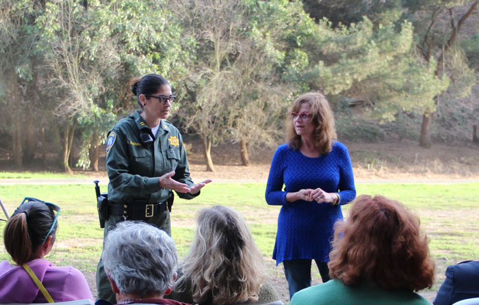 Gina Farr (right) of Project Coyote joins a city parks official to introduce a recent workshop on coyote hazing—techniques to intimidate coyotes to maintain their natural fear of humans—at Pine Lake Park. (Photo by Graelyn Brashear)