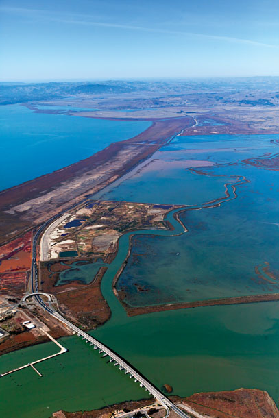 Aerial view looking west from Vallejo over the Napa River. Beyond the Highway 37 bridge is the (unbreached) "future phase" section of Cullinan, with the open water of the recently breached section behind. San Pablo Bay is on the left; Dutchman Slough, to the right, snakes between Cullinan and Pond 3 and then flows into the river. (Photo by David Siervert, AirPhoto Designs)