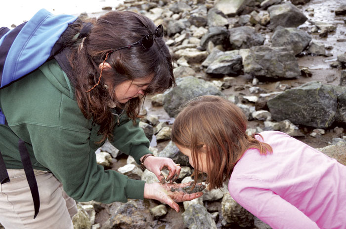 EBRPD naturalist Susan Ramos holds a green shore crab for closer examination. (Photo by Sally Rae Kimmel)