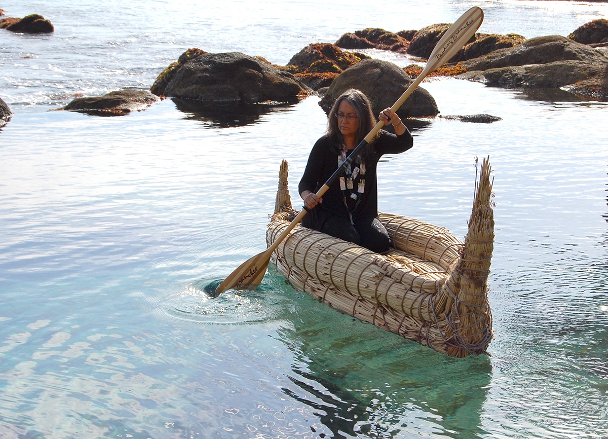 linda yamane paddles a tule canoe
