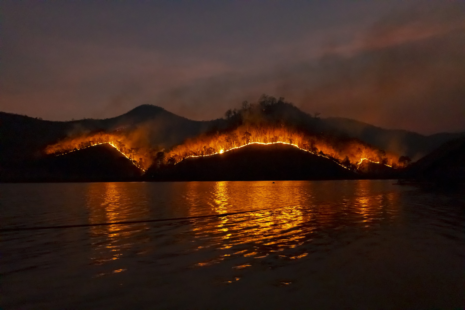 Wildfire burning along a lake